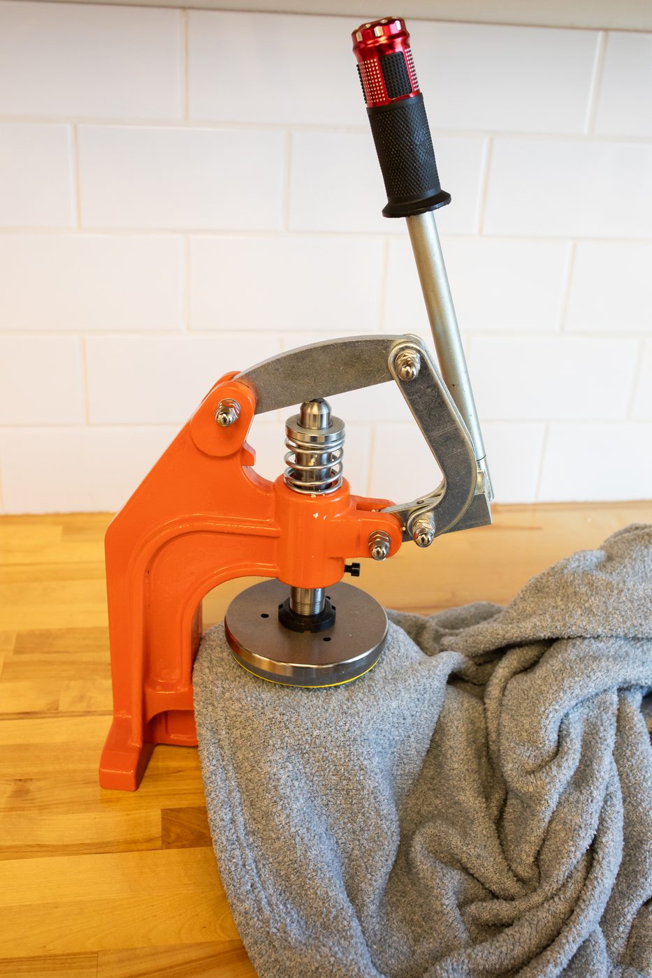 Cutting die punching a swatch from PajamaGram's single-layer fabric