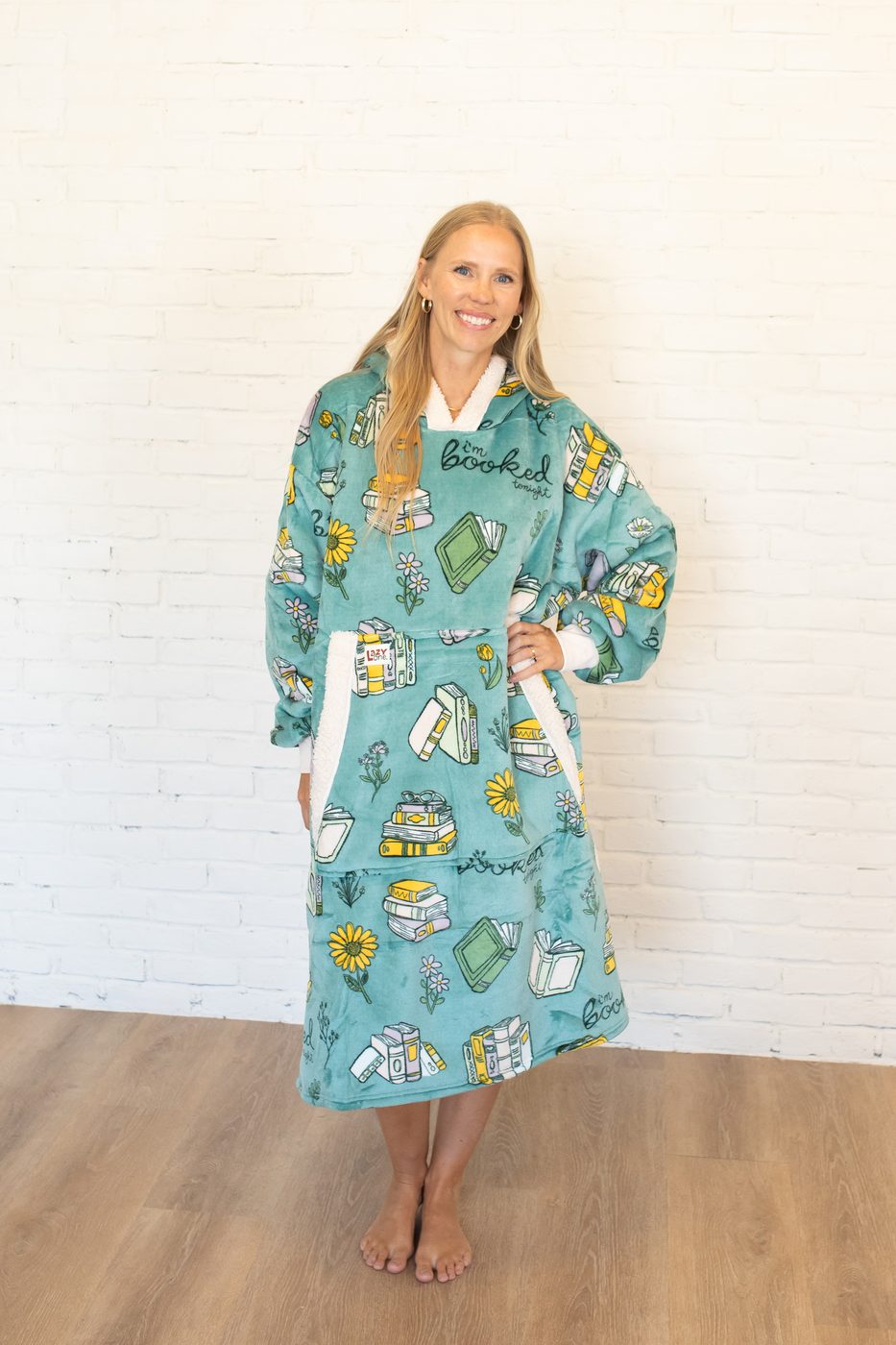 LazyOne blanket hoodie worn, sage green book-print